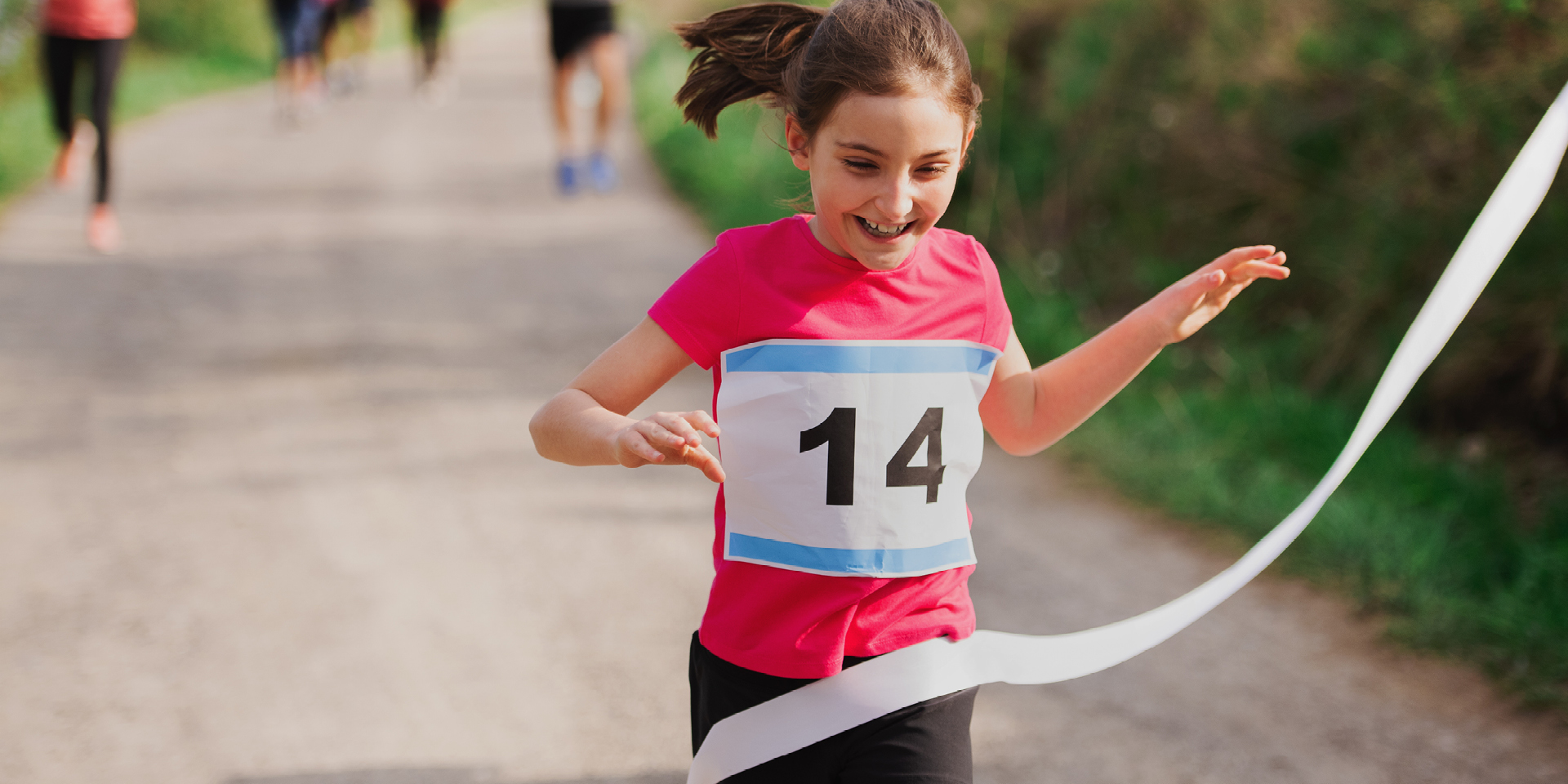 young girl reaching finish line