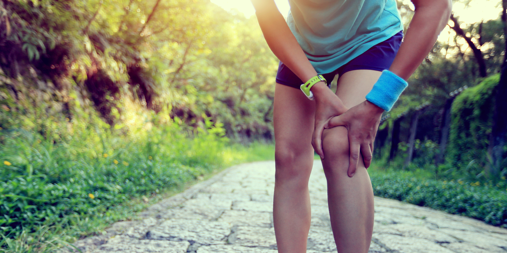 female runner holding knee in pain