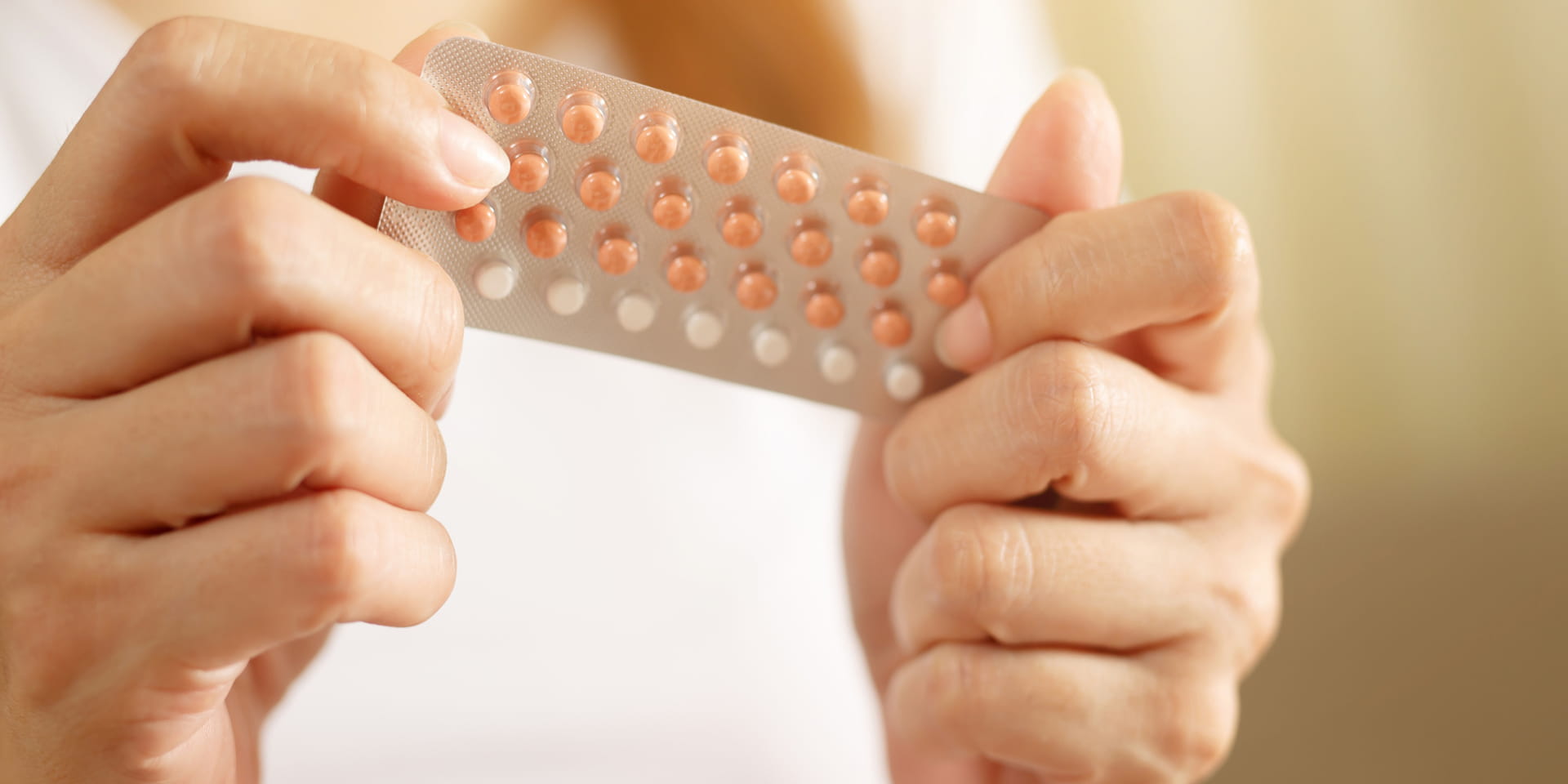 Woman holding birth control pills | Doylestown Health