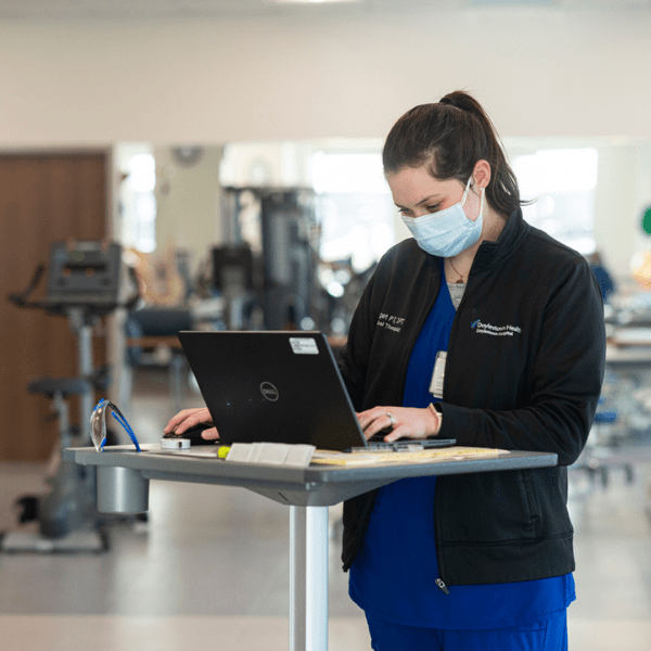 Doylestown Health Associate  using a laptop | Doylestown Health