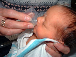 Mother cup feeding her baby | Doylestown Health