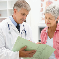 Provider reviewing a file with a patient | Doylestown Health