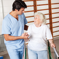 A therapist helping an elderly lady | Doylestown Health