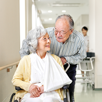 Elderly woman on a wheelchair with husband | Doylestown Health